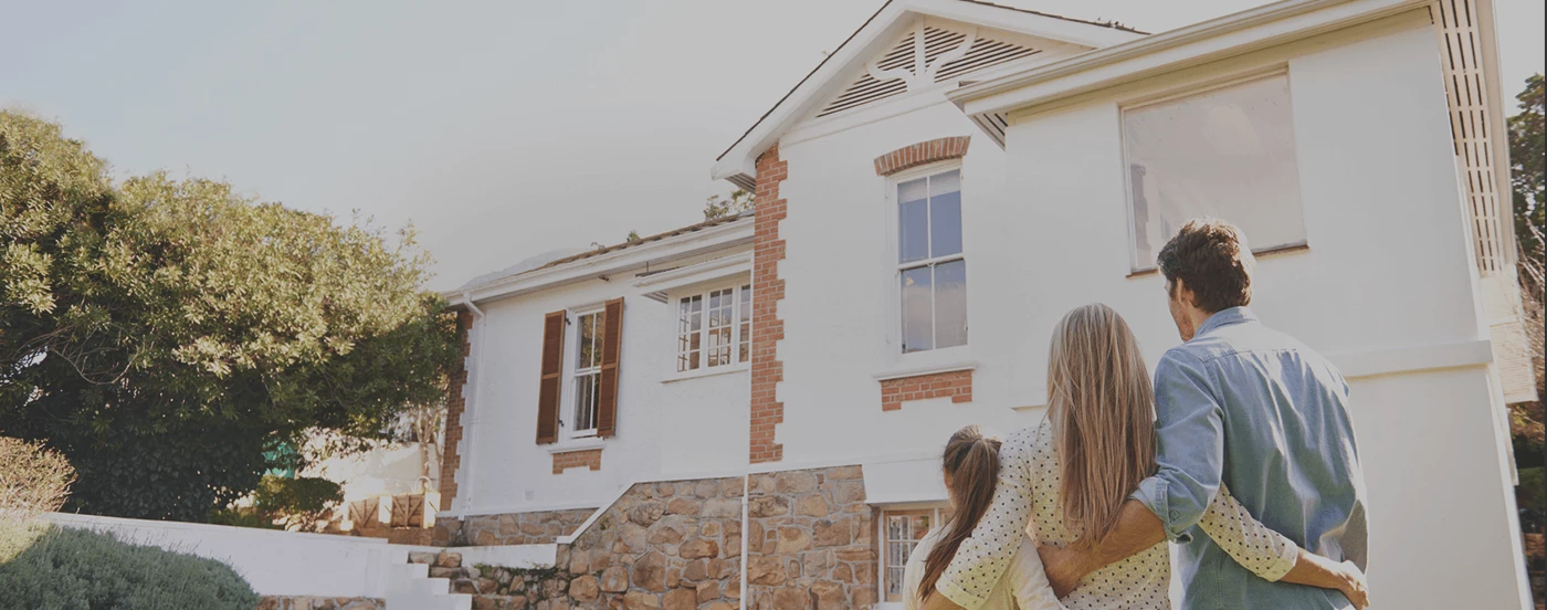 family-looking-at-house