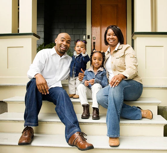 family-sitting-on-doorstep
